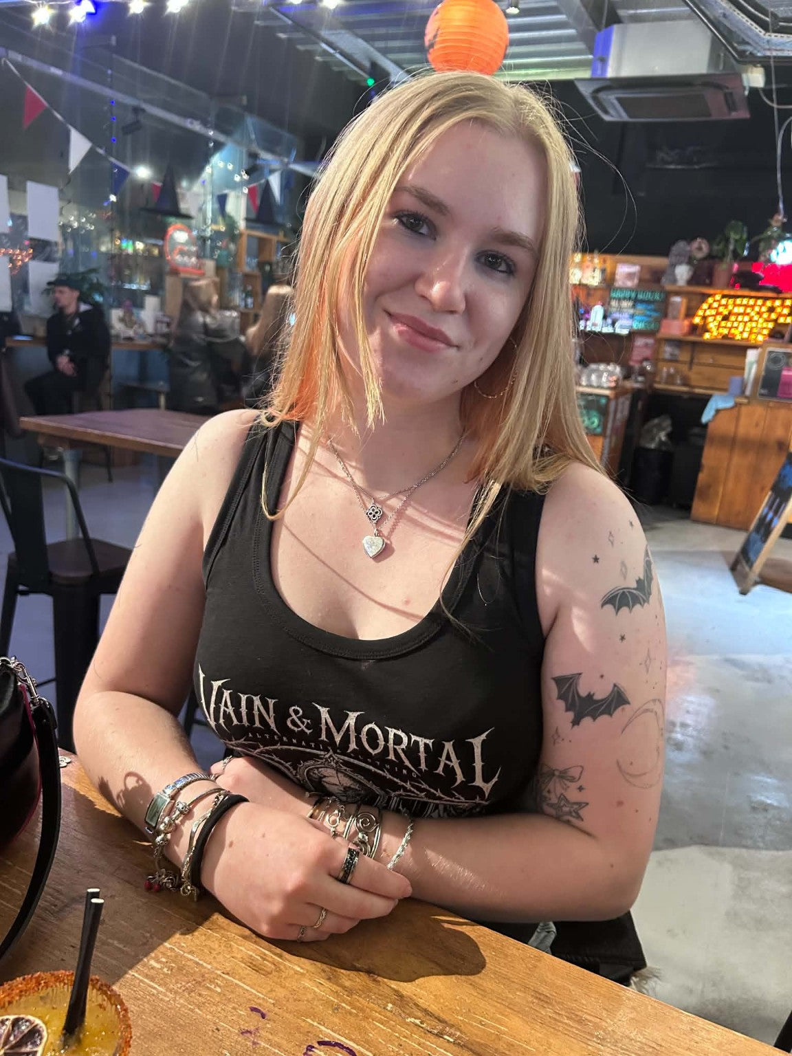 Jessica wearing the VAIN & MORTAL Beauty Fades. Art Remains. fitted black organic cotton gothic vest in a real-life photograph.