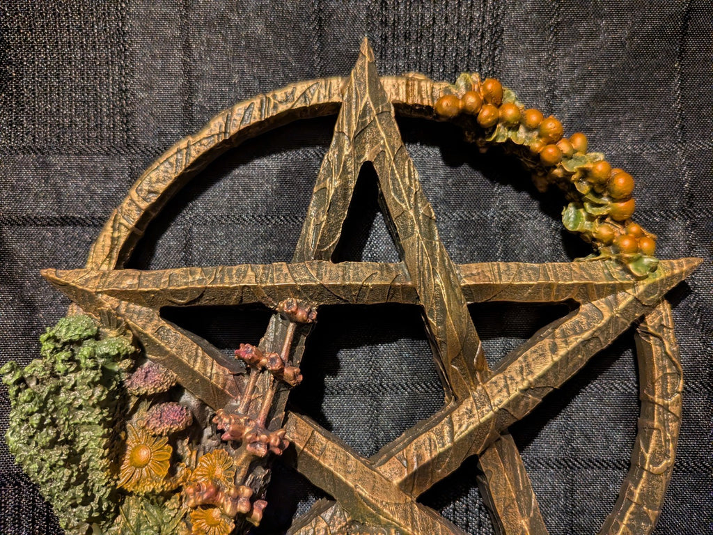 Litha golden pentagram star and orange berries close-up