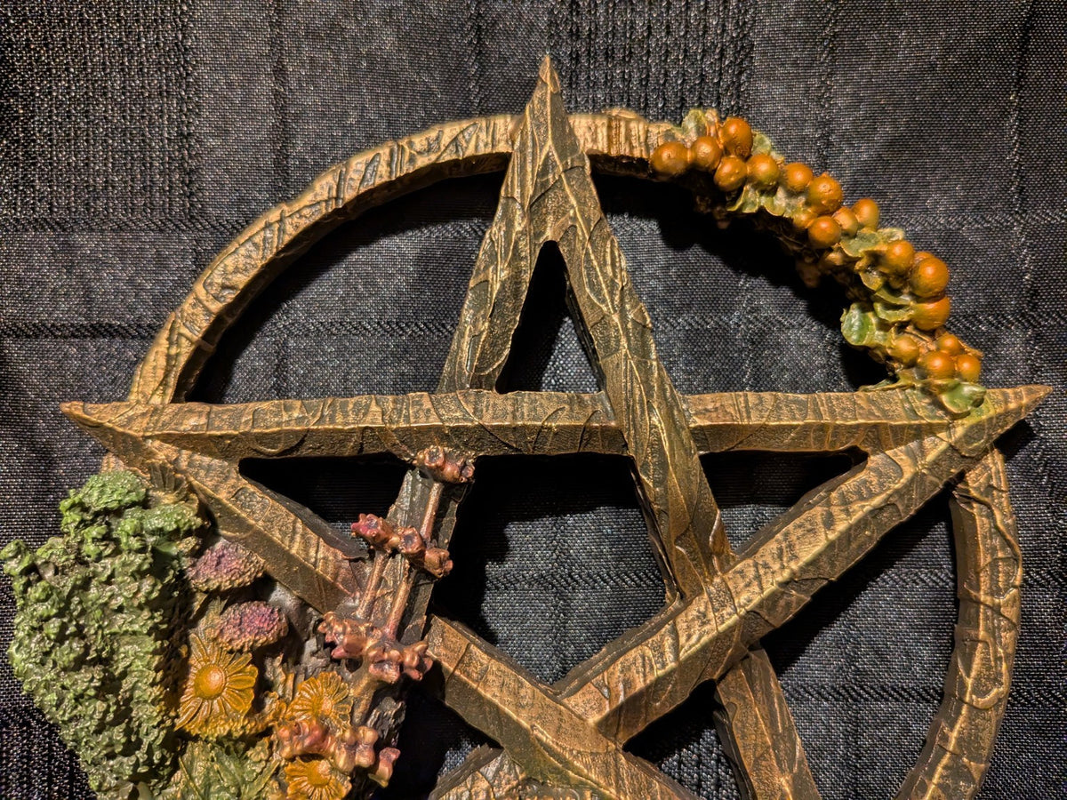 Litha golden pentagram star and orange berries close-up