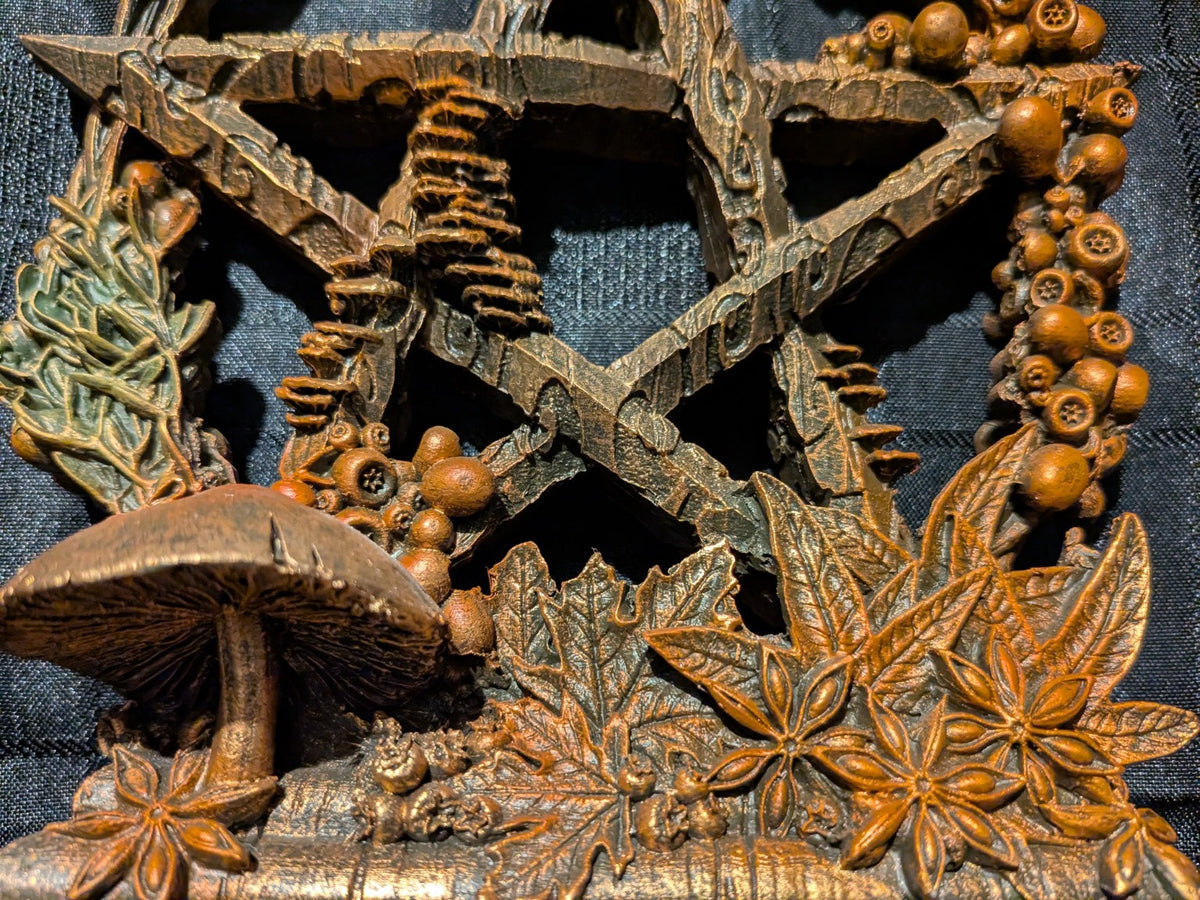 Mabon pentagram mushrooms and carved golden autumn leaves close-up