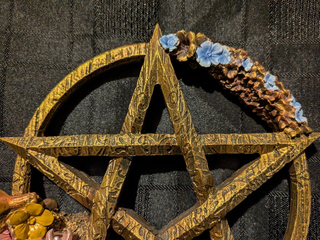 Ostara wood-effect pentagram and blue blossom close-up