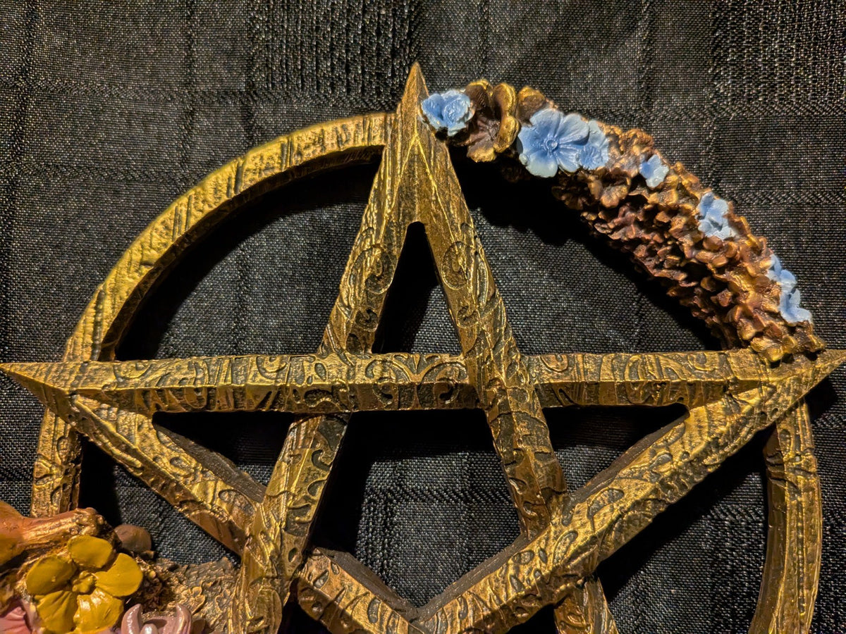 Ostara wood-effect pentagram and blue blossom close-up