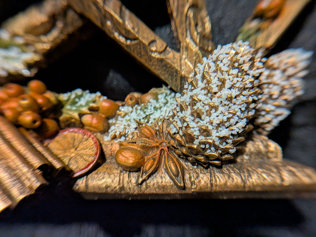Nemesis Now Yule pentagram close-up of frosted pinecone and star anise