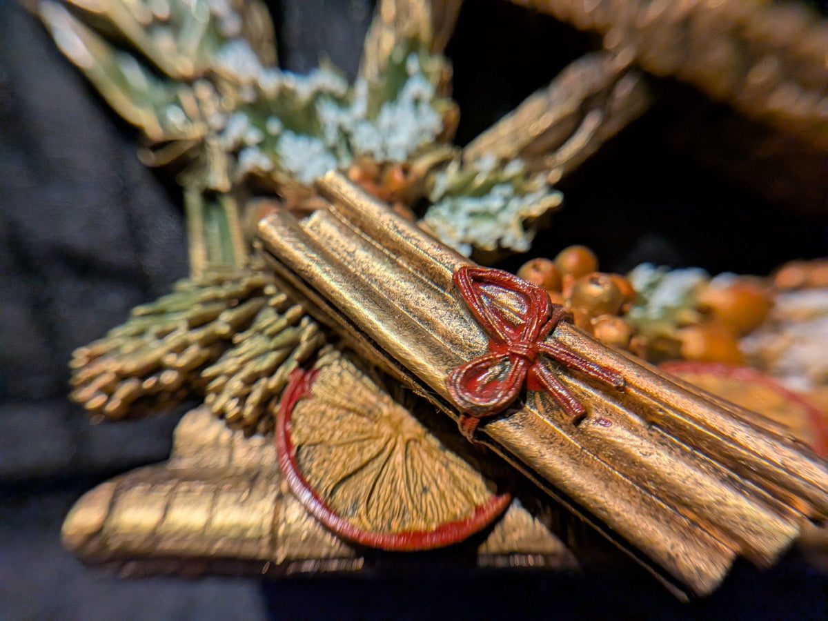 Yule pentagram seasonal cinnamon bundle and dried orange close-up
