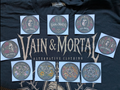 Nine VAIN & MORTAL sticker designs arranged on a black shirt